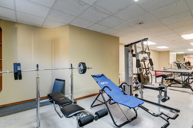 workout room with a paneled ceiling