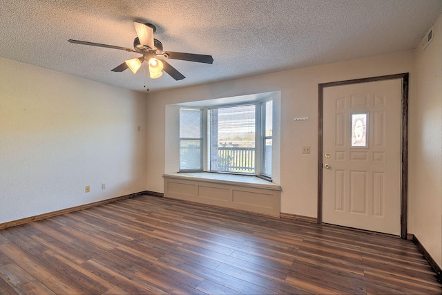 entryway featuring ceiling fan, a textured ceiling, and dark hardwood / wood-style floors