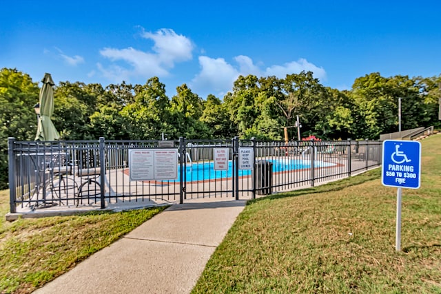 view of swimming pool with a lawn