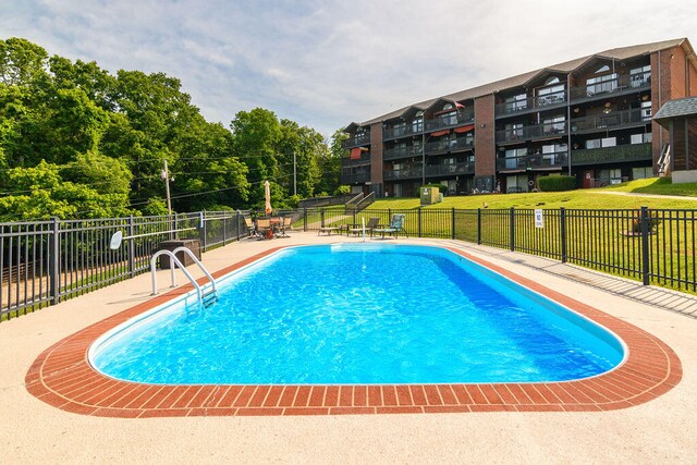 view of pool featuring a yard