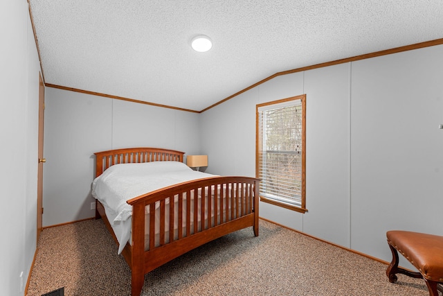 bedroom featuring carpet floors, a textured ceiling, lofted ceiling, and ornamental molding