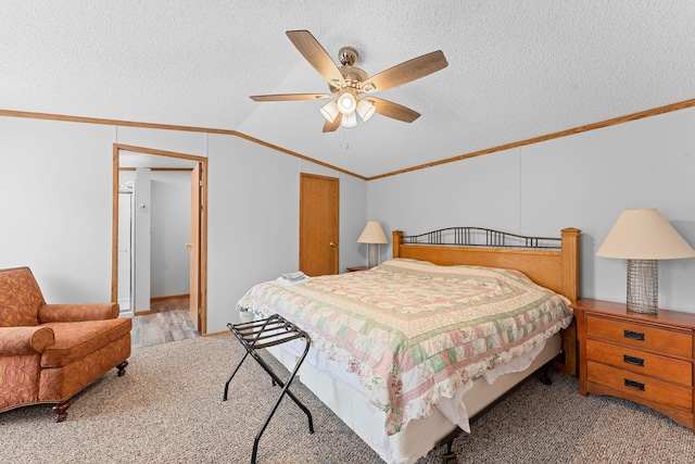 bedroom featuring ceiling fan, lofted ceiling, carpet flooring, a textured ceiling, and crown molding