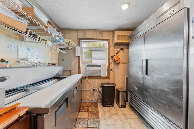 misc room with a wall unit AC, electric panel, cooling unit, wood walls, and a textured ceiling