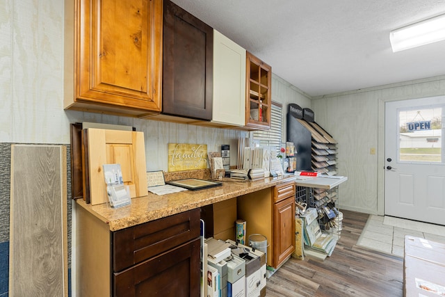 kitchen featuring dark hardwood / wood-style flooring, light stone counters, and a textured ceiling