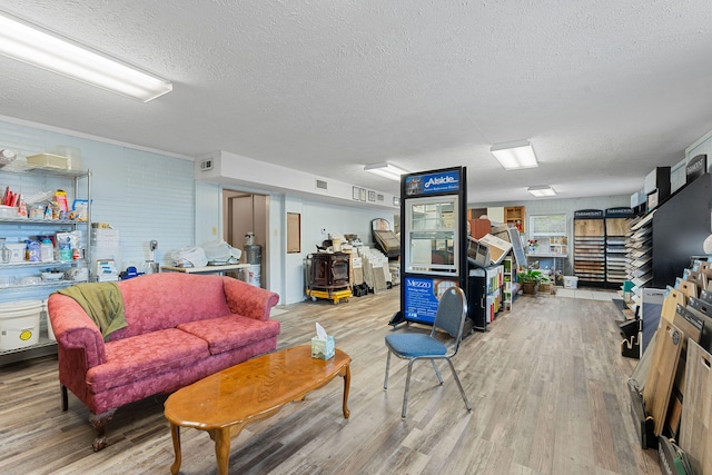 living room with wood-type flooring and a textured ceiling