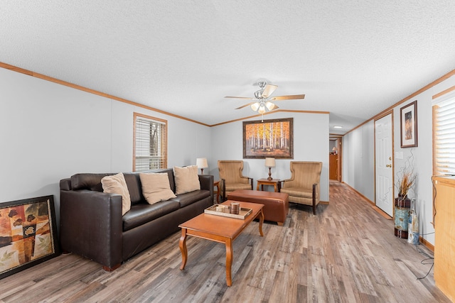 living room with a textured ceiling, hardwood / wood-style floors, and a wealth of natural light