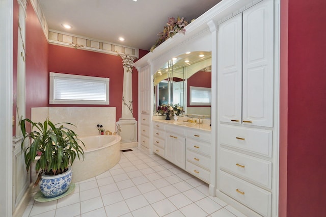 bathroom featuring ornate columns, a bathtub, tile patterned floors, and vanity