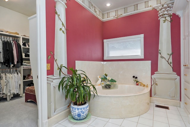 bathroom with tile patterned flooring and a bath