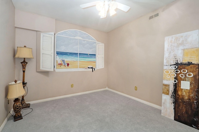 carpeted empty room featuring ceiling fan