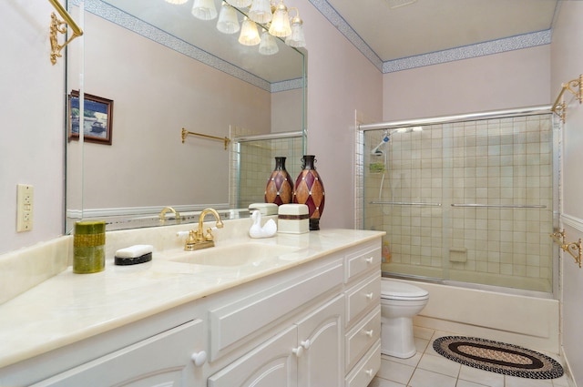 full bathroom featuring tile patterned flooring, shower / bath combination with glass door, vanity, and toilet