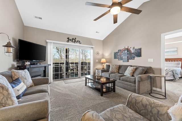 carpeted living room with high vaulted ceiling and ceiling fan