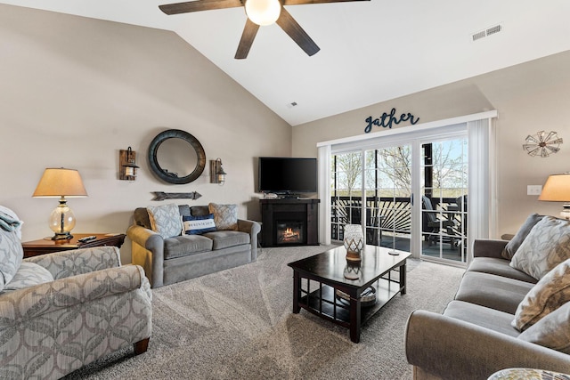 280 Tina St Unit 9, Hollister, MO 65672 - carpeted living room featuring high vaulted ceiling, ceiling fan, a glass covered fireplace, and visible vents