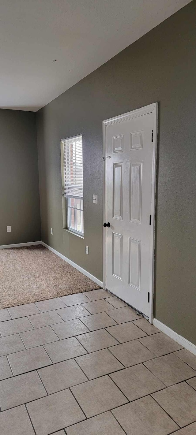 entryway featuring light colored carpet