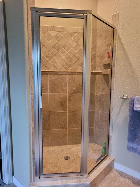 bathroom featuring a shower with shower door