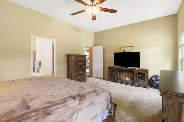 carpeted bedroom featuring ensuite bath and ceiling fan