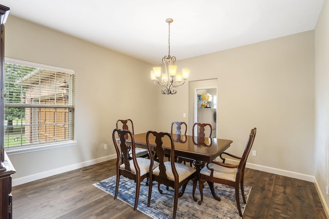 dining space featuring an inviting chandelier and dark hardwood / wood-style flooring