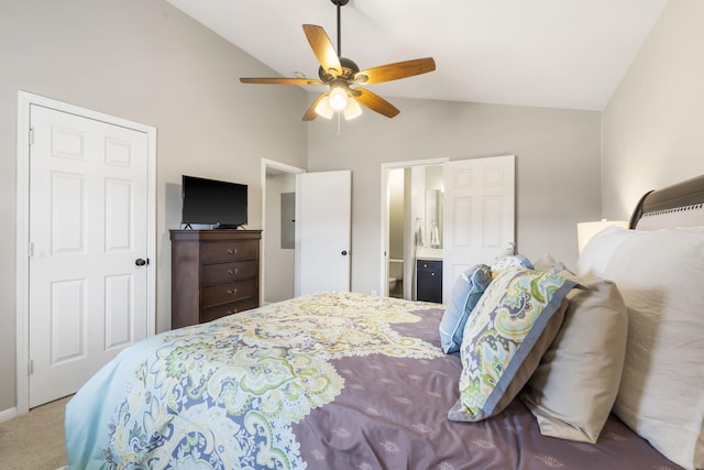 bedroom featuring ceiling fan, electric panel, carpet floors, ensuite bath, and vaulted ceiling