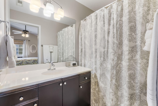 bathroom featuring ceiling fan, vanity, and lofted ceiling