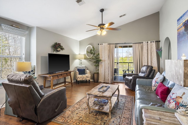 living room with lofted ceiling, ceiling fan, and dark hardwood / wood-style floors