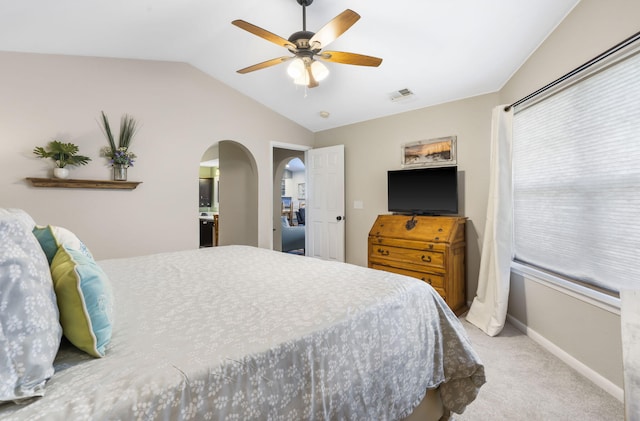 bedroom with lofted ceiling, light colored carpet, and ceiling fan