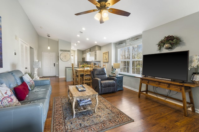 living room featuring dark hardwood / wood-style floors and ceiling fan