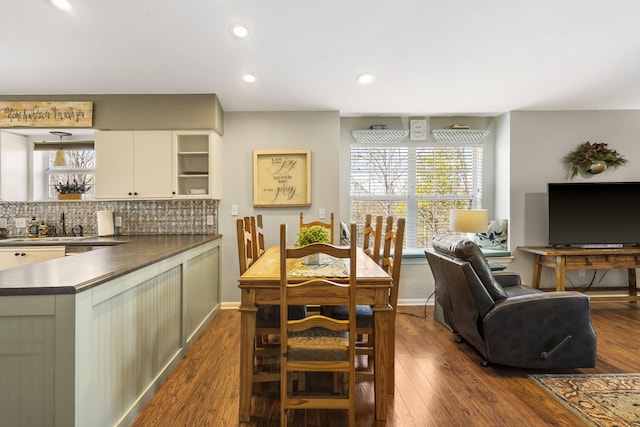 dining space featuring a wealth of natural light and dark hardwood / wood-style flooring