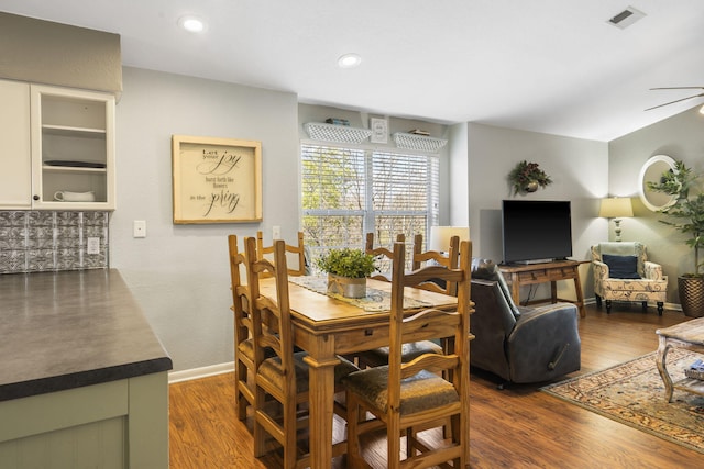 dining room with ceiling fan and dark wood-type flooring