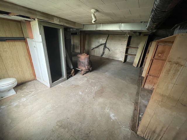 basement featuring wooden walls