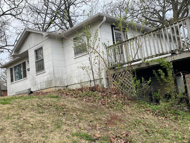 view of home's exterior featuring a wooden deck