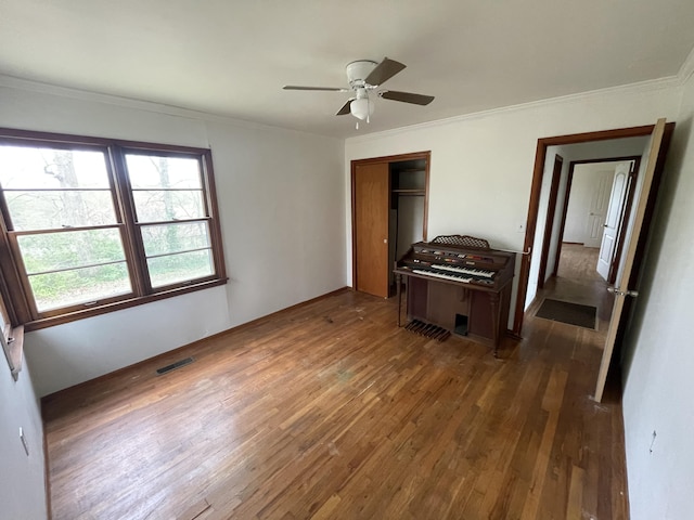 601 Texas St, West Plains, MO 65775 - bedroom with crown molding, hardwood / wood-style floors, visible vents, and a closet