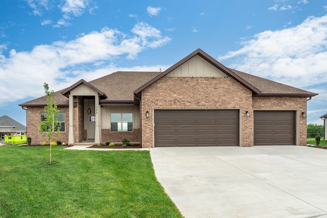 view of front of property with a front yard and a garage