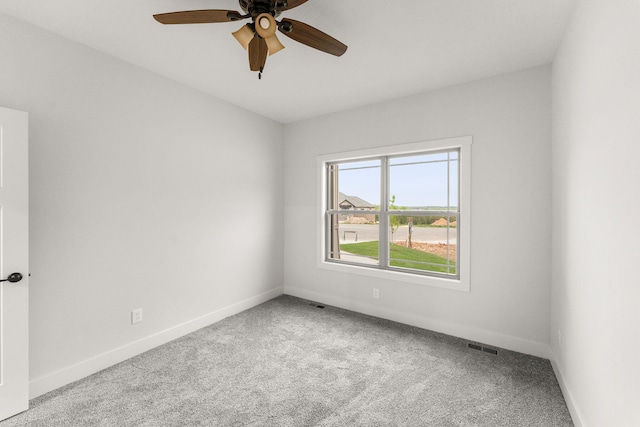 spare room featuring light carpet and ceiling fan