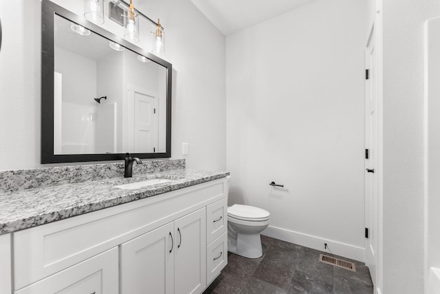 bathroom with a shower, vanity, and toilet