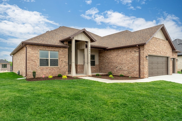 view of front of property featuring a garage and a front lawn