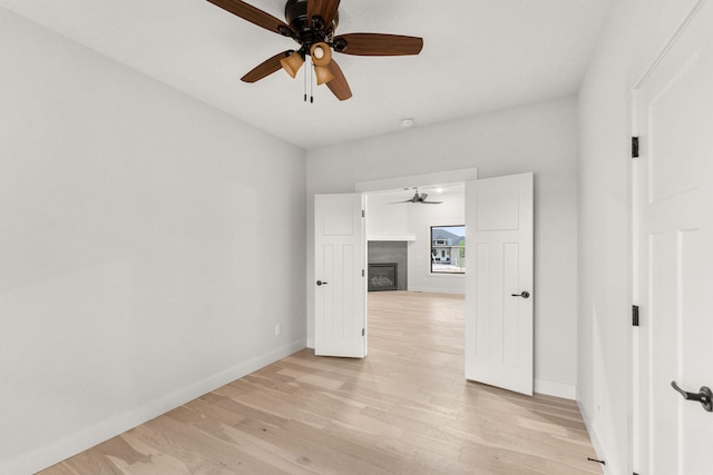 empty room featuring ceiling fan and light hardwood / wood-style floors