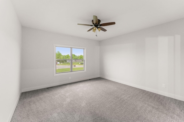 carpeted spare room featuring ceiling fan