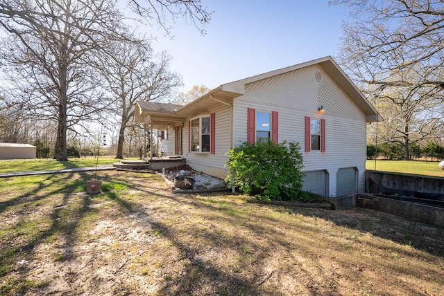 view of home's exterior with a garage and a lawn