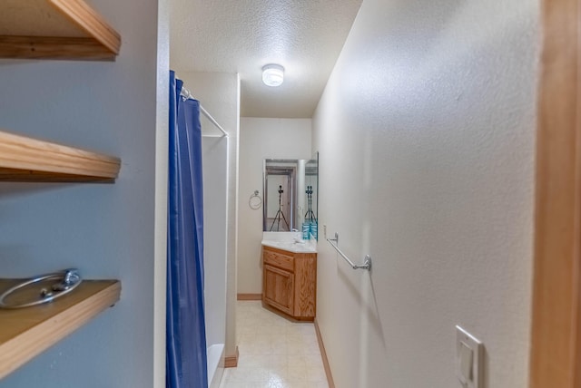 bathroom featuring vanity, a textured ceiling, and a shower with shower curtain