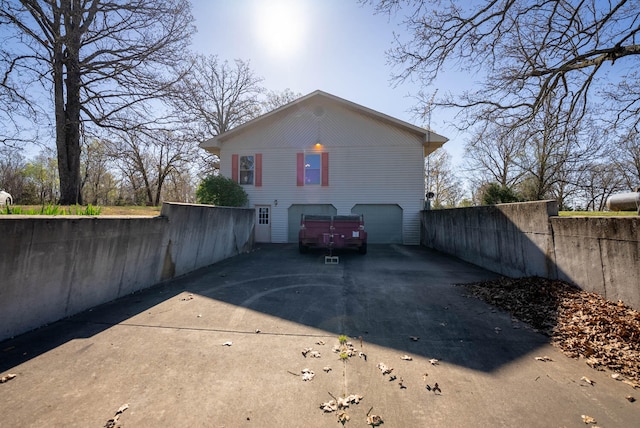 rear view of property featuring a garage