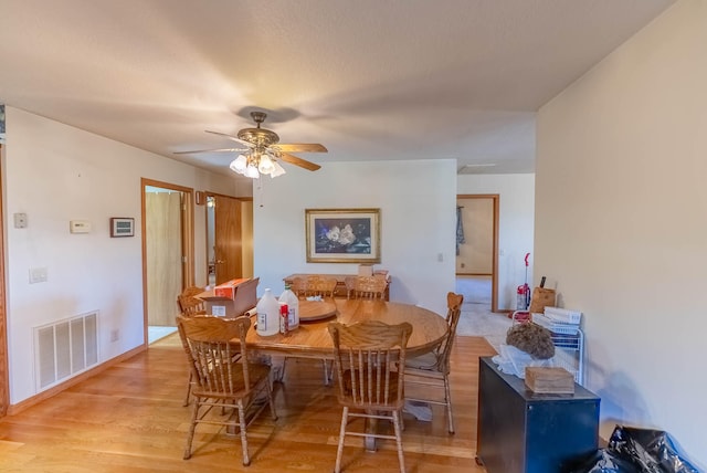 dining room featuring ceiling fan and light wood-type flooring