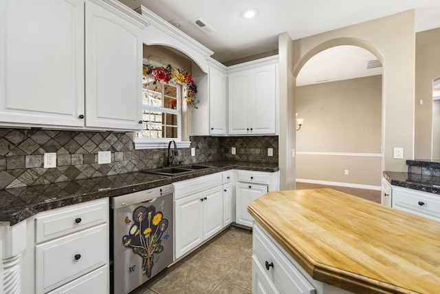 kitchen featuring white cabinets, visible vents, a sink, and stainless steel dishwasher