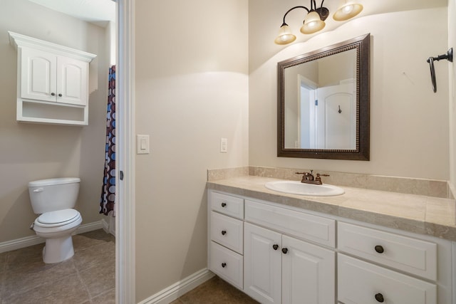 full bathroom featuring tile patterned flooring, vanity, toilet, and baseboards