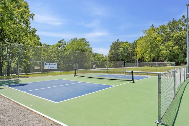 view of tennis court featuring fence