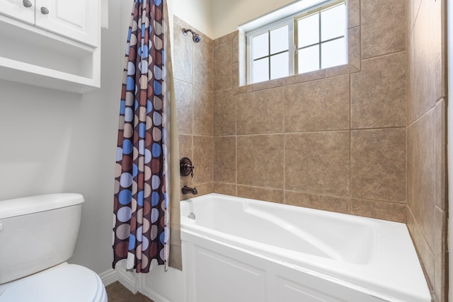 bathroom featuring toilet and shower / tub combo with curtain