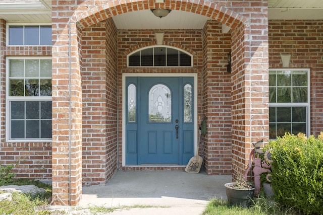 property entrance featuring brick siding