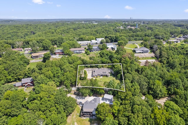 bird's eye view with a wooded view