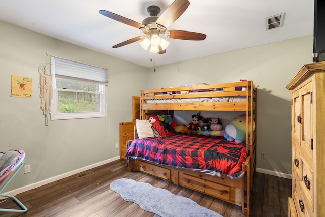 bedroom with ceiling fan, baseboards, wood finished floors, and visible vents