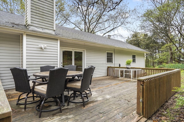 wooden terrace featuring outdoor dining area