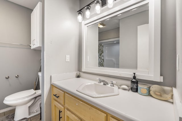 bathroom featuring a shower with curtain, vanity, toilet, and tile patterned floors