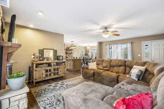 living room with ceiling fan and dark hardwood / wood-style flooring